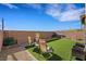 Landscaped backyard featuring artificial grass, a privacy wall, and ample space for entertaining at 2849 Mincio St, Henderson, NV 89044