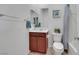 Bright bathroom featuring a vanity with cherry cabinets and a full toilet and shower at 2849 Mincio St, Henderson, NV 89044