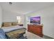 Cozy bedroom features a bed, a television, and a dresser against a white wall at 2849 Mincio St, Henderson, NV 89044