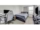 Bedroom featuring a modern gaming setup with a large bed and neutral color palette at 2849 Mincio St, Henderson, NV 89044