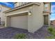 Close-up of two-car garage and front entrance. Home number is visible above garage at 2849 Mincio St, Henderson, NV 89044