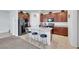 Modern kitchen features dark wood cabinets, a black stainless steel refrigerator, and a granite countertop island with seating at 2849 Mincio St, Henderson, NV 89044