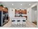 This kitchen features dark wood cabinets, granite countertops, stainless steel appliances, and an island with seating at 2849 Mincio St, Henderson, NV 89044