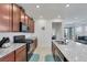 Well-equipped kitchen with dark wood cabinets, granite countertops, and modern stainless steel appliances for comfortable cooking at 2849 Mincio St, Henderson, NV 89044