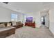 Cozy living room with plush seating, a media console, and large windows for ample lighting at 2849 Mincio St, Henderson, NV 89044