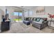 This living room boasts a large sectional sofa, access to the backyard, and plenty of natural light for comfortable living at 2849 Mincio St, Henderson, NV 89044