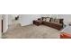 Spacious living room featuring neutral carpet, a sectional sofa and access to other rooms at 2849 Mincio St, Henderson, NV 89044