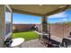 Covered patio area with brick flooring, view of the backyard, and space for seating at 2849 Mincio St, Henderson, NV 89044