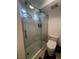 Bathroom features a modern glass shower with decorative tile and updated fixtures at 2857 Queens Courtyard Dr, Las Vegas, NV 89109