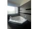 Modern bathroom features a stylish jetted tub and a large window at 2857 Queens Courtyard Dr, Las Vegas, NV 89109