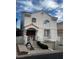Charming two-story home featuring a well-manicured yard, a unique facade, and attached garage at 2857 Queens Courtyard Dr, Las Vegas, NV 89109