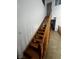 Well-lit stairway with hardwood steps and banister, and tile floors at 2857 Queens Courtyard Dr, Las Vegas, NV 89109