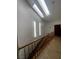 Elegant stairway featuring a skylight, chandelier, and stylish tile floors at 2857 Queens Courtyard Dr, Las Vegas, NV 89109