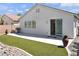 Backyard featuring artificial turf, desert landscaping and a sliding glass door at 3032 Hartley Cove Ave, North Las Vegas, NV 89081