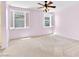 Spacious bedroom with neutral carpet, a ceiling fan, and shuttered windows allowing for natural light at 3032 Hartley Cove Ave, North Las Vegas, NV 89081