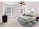 Stylish bedroom featuring neutral decor, ceiling fan, and bright natural light from shuttered windows at 3032 Hartley Cove Ave, North Las Vegas, NV 89081