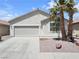 Lovely single-story home featuring a two-car garage, desert landscaping with mature palm trees at 3032 Hartley Cove Ave, North Las Vegas, NV 89081