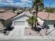 Charming single-story home with a two-car garage, desert landscaping, and mountain views in the background at 3032 Hartley Cove Ave, North Las Vegas, NV 89081