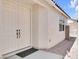 Inviting double door entrance to a home with neutral paint and desert landscaping at 3032 Hartley Cove Ave, North Las Vegas, NV 89081