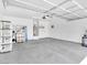 Spacious two-car garage with ample storage shelving and concrete flooring, providing functionality and organization at 3032 Hartley Cove Ave, North Las Vegas, NV 89081