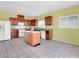 The bright kitchen features wood cabinets, an island, tile floors, and stainless steel appliances at 3032 Hartley Cove Ave, North Las Vegas, NV 89081