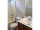 Bathroom with a tub, toilet, and sink with wood cabinets at 3123 Inlet Bay Ave, North Las Vegas, NV 89031