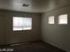 Bedroom with carpeted floors, neutral walls, and three windows for natural light at 3123 Inlet Bay Ave, North Las Vegas, NV 89031
