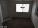Neutral dining room with a light fixture, carpeted floors, and natural lighting at 3123 Inlet Bay Ave, North Las Vegas, NV 89031