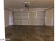 Spacious four car garage with concrete floors and a large garage door at 3123 Inlet Bay Ave, North Las Vegas, NV 89031