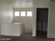 Upstairs hallway featuring three windows and an open laundry room at 3123 Inlet Bay Ave, North Las Vegas, NV 89031