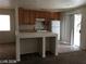 Kitchen featuring oak cabinets, a breakfast bar, and a sliding glass door at 3123 Inlet Bay Ave, North Las Vegas, NV 89031