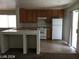Kitchen featuring oak cabinets, a breakfast bar, and a sliding glass door at 3123 Inlet Bay Ave, North Las Vegas, NV 89031