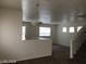 A spacious open floorplan with a light fixture, neutral walls, and carpeted floors at 3123 Inlet Bay Ave, North Las Vegas, NV 89031