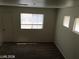 Bright living room featuring neutral paint, carpeted floors, and natural light from large windows at 3123 Inlet Bay Ave, North Las Vegas, NV 89031