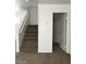 Carpeted staircase in a neutrally painted home with white trim and door at 3123 Inlet Bay Ave, North Las Vegas, NV 89031