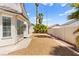 An exterior view of the home's backyard featuring low maintenance rock landscaping and desert plants at 313 Firestone Dr, Las Vegas, NV 89145