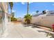 Spacious backyard with concrete patio, palm trees, and desert landscaping, perfect for outdoor entertaining at 313 Firestone Dr, Las Vegas, NV 89145