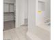 Bright bathroom features a tiled tub and walk-in closet with custom built-in shelving at 313 Firestone Dr, Las Vegas, NV 89145
