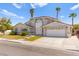 Attractive single-Gathering home with a manicured lawn, a two-car garage and mature landscaping at 313 Firestone Dr, Las Vegas, NV 89145