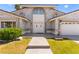Striking entryway with stone accents, a two car garage, and meticulously maintained front yard at 313 Firestone Dr, Las Vegas, NV 89145