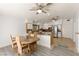Bright kitchen and dining area with tile and laminate floors, stainless steel appliances, and two ceiling fans at 313 Firestone Dr, Las Vegas, NV 89145