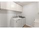 Bright laundry room with modern washer and dryer machines and storage at 313 Firestone Dr, Las Vegas, NV 89145