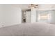 Spacious living room with plush carpet, window views, and a ceiling fan for added comfort at 313 Firestone Dr, Las Vegas, NV 89145