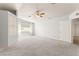 Large living room with carpet flooring, neutral paint, and built-in storage cabinets at 313 Firestone Dr, Las Vegas, NV 89145