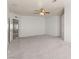 Expansive carpeted living room featuring neutral walls, ceiling fan, and doorway view to another room at 313 Firestone Dr, Las Vegas, NV 89145