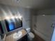 Bathroom with dark cabinets, mirror, and shower and bathtub combo at 3151 Soaring Gulls Dr # 1092, Las Vegas, NV 89128