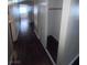 View of long hallway with dark wood floors and a closet with an open door at 3151 Soaring Gulls Dr # 1092, Las Vegas, NV 89128
