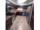 Kitchen with stainless steel appliances, tile floor, and wood cabinets at 3151 Soaring Gulls Dr # 1092, Las Vegas, NV 89128