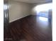Living room with hardwood floors and sliding glass door to the outside at 3151 Soaring Gulls Dr # 1092, Las Vegas, NV 89128