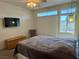 Inviting bedroom featuring a ceiling fan, natural light, and comfortable furnishings at 3263 Quail Song Dr, Laughlin, NV 89029